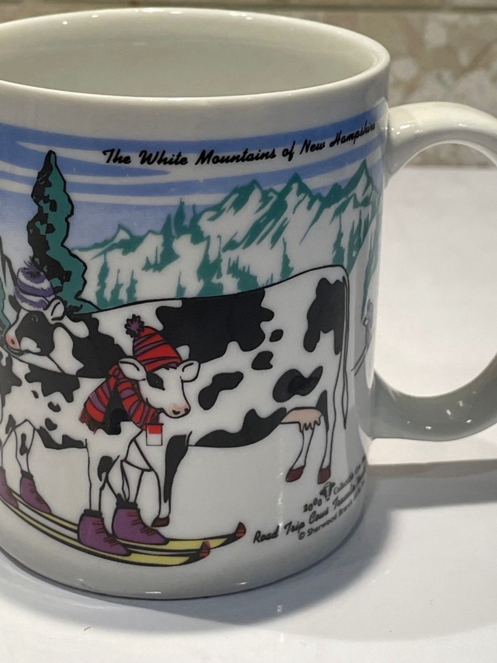 White Mountain Cow Ski Ceramic Coffee Mug - White, Black, Purple